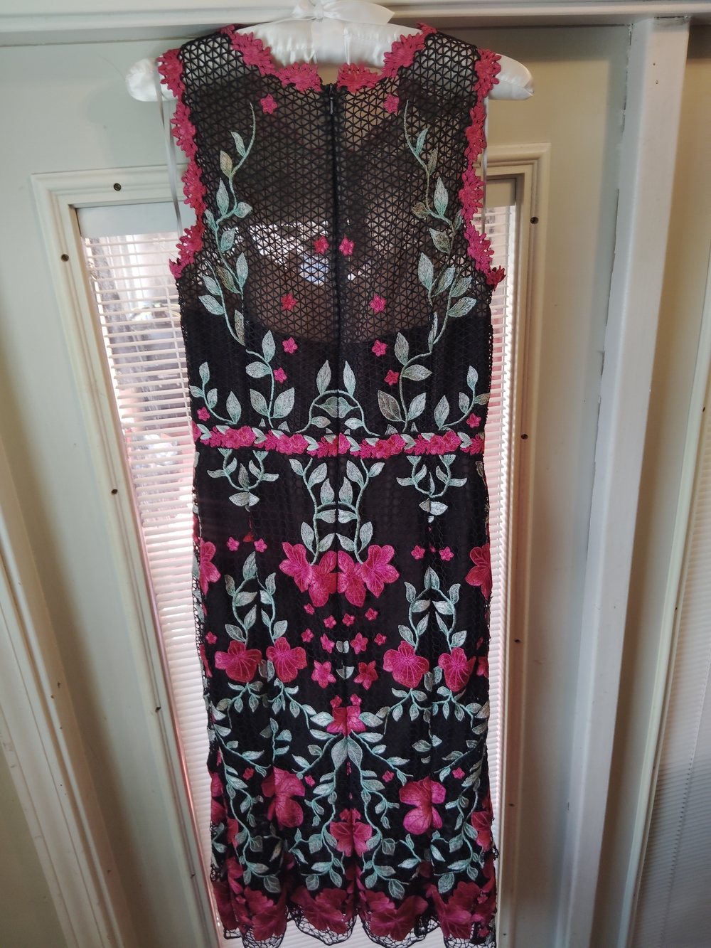 This is a black sleeveless midi dress by Marchesa Notte